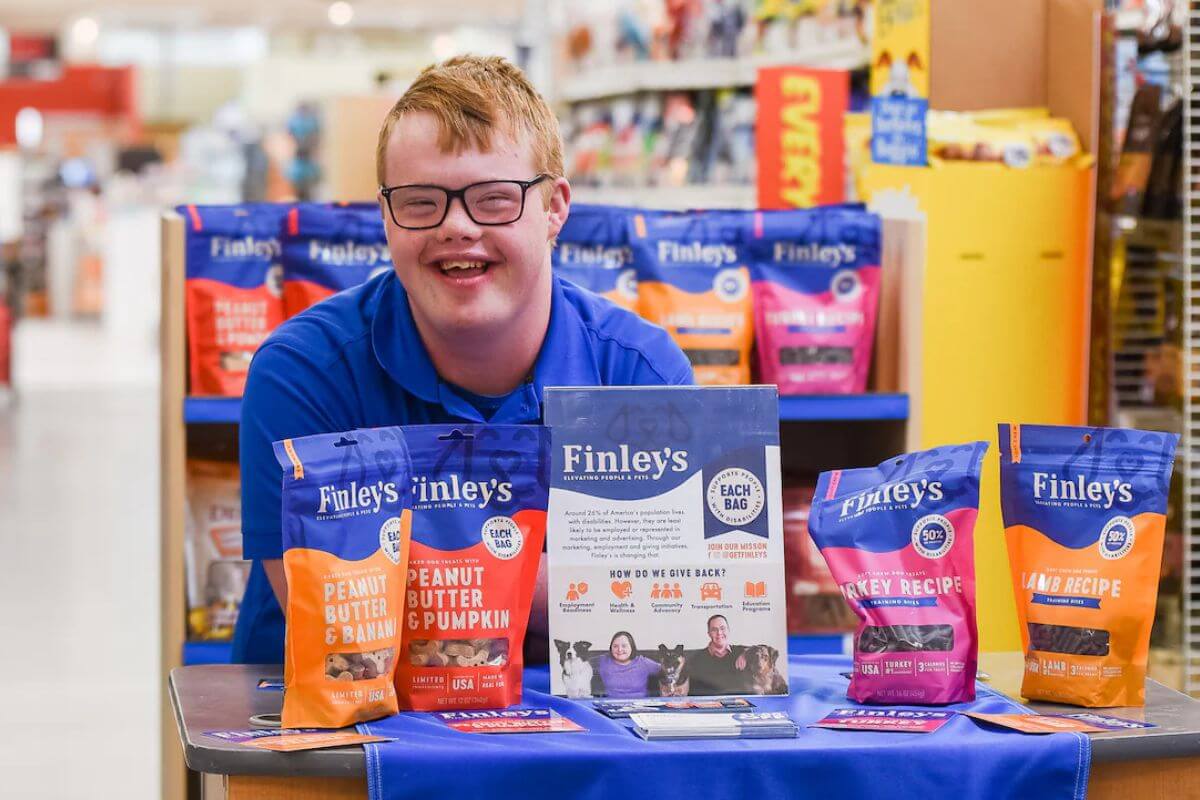 Finley's ambassador in a store setting with Finley's dog treat products on display