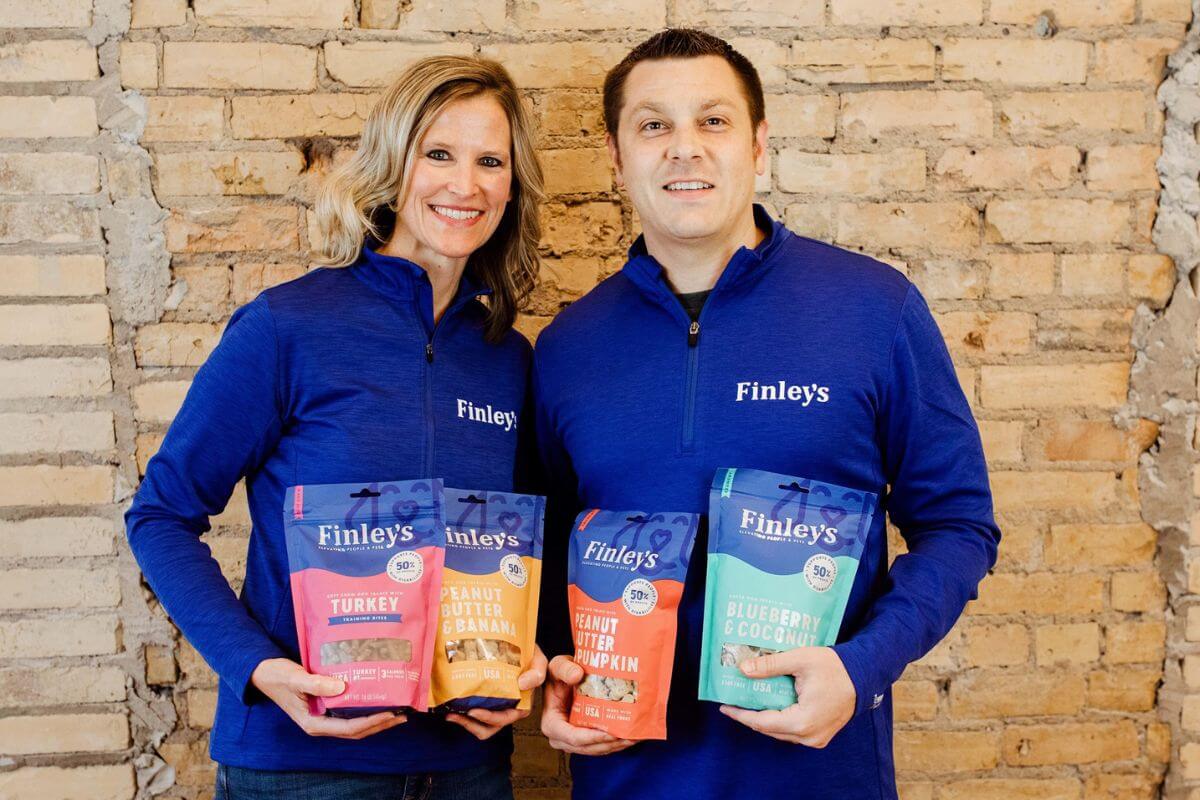 Kyle and Angie Gallus holding bags of Finley's dog treats