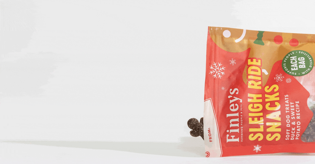 Animation of gingerbread man shaped treat tumbling out of a bag of Sleigh Ride Snacks.